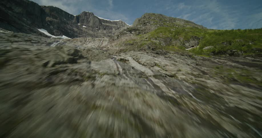 A mountain range covered in grass and snow