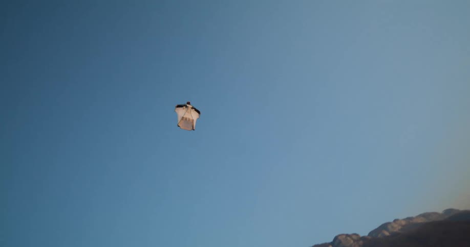 A person paragliding over the landscape