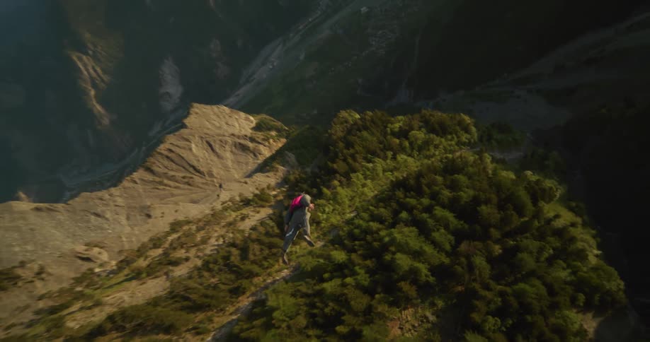 The view is of someone jumping out of a parachute around the nature area