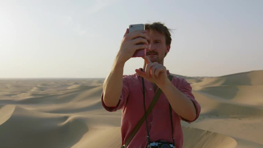 Man takes a picture of himself in the middle of a desert