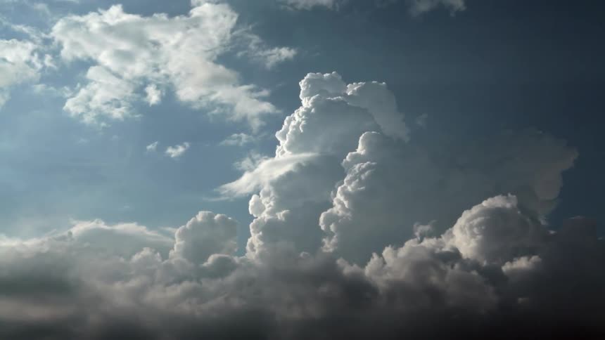 Large clouds move in a blue sky