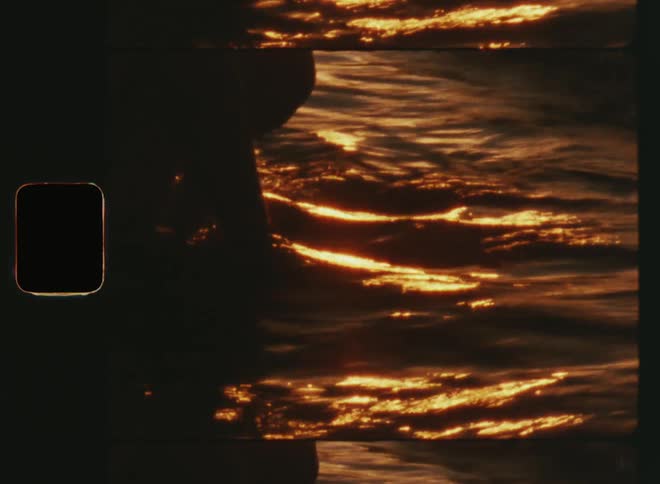 Sunshine reflecting off water and a young girl or woman putting her hands in the waves and in the sand touching the ground enjoying the sensory impression after water drips from her fingers in the bright golden evening sun