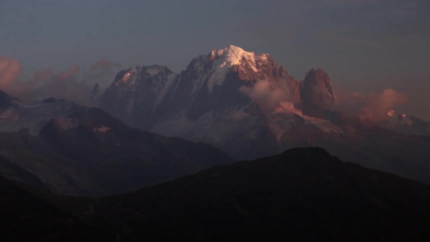 A mountain range has clouds near the surface