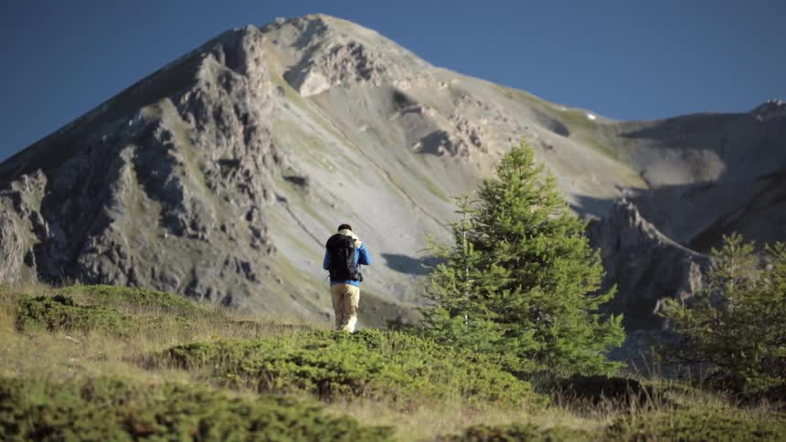 A person is hiking towards a mountain