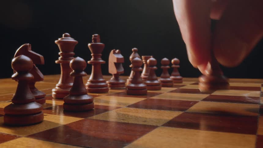 A person is playing chess indoors