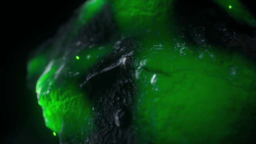 A Radioactive rock rotates around as it emits particles