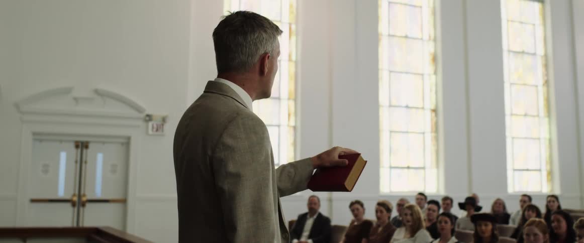 A priest is talking to people at a church