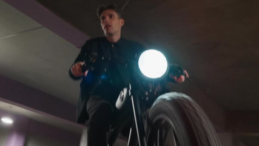 A man is riding a bike outdoors at night time