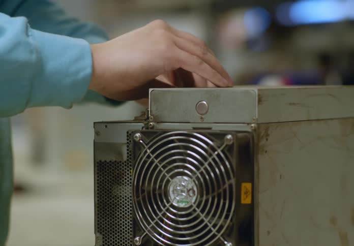 A worker inside of factory fixing computer equipment