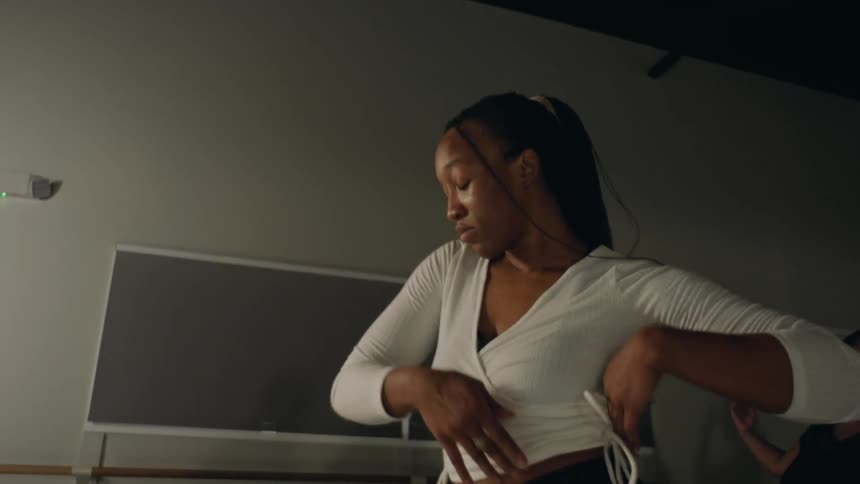 Women are dancing inside of a studio in the day time
