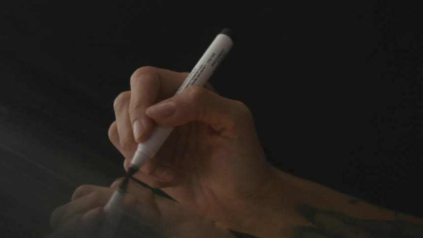 A person is using a marker