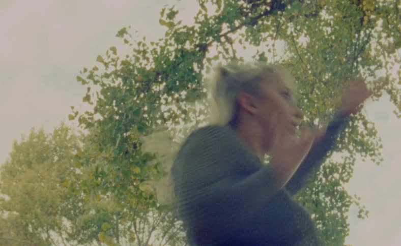 Blonde dancer moves through dance poses under trees starting to turn yellow