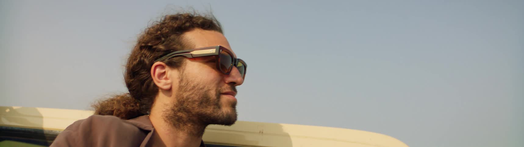 A man is smiling outside