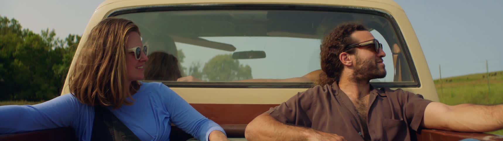 Man and woman are riding in a truck together