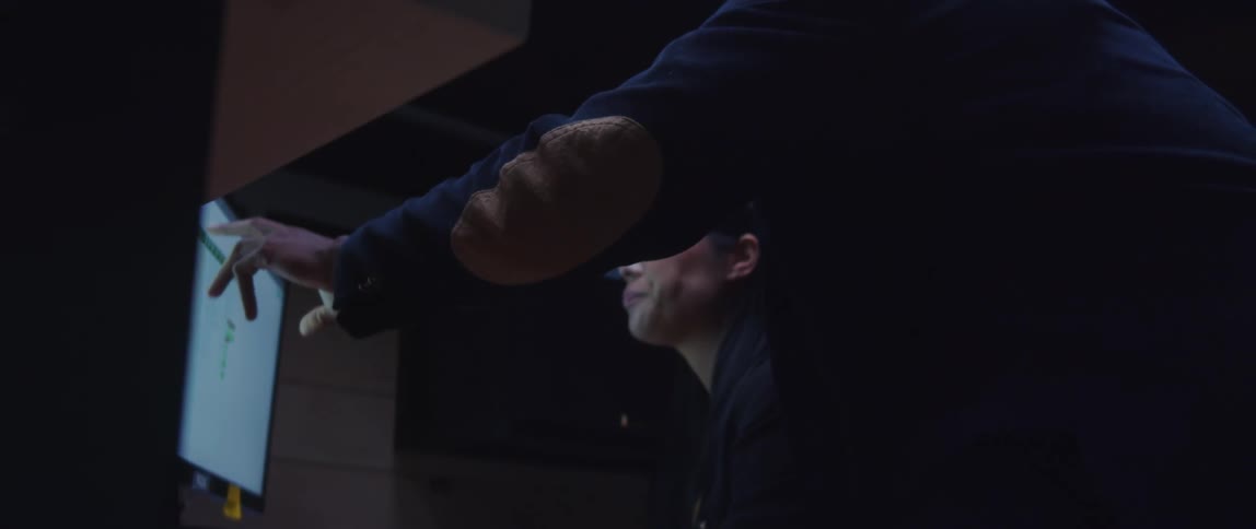Two people working on an excel sheet