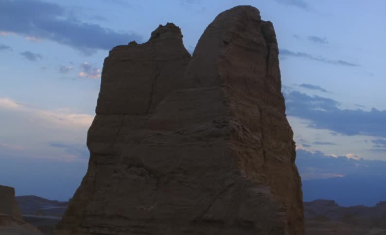 A mountain peak against a dusk sky