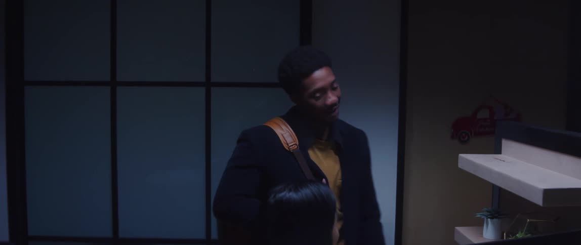 A man stops to chat with a colleague when leaving the office