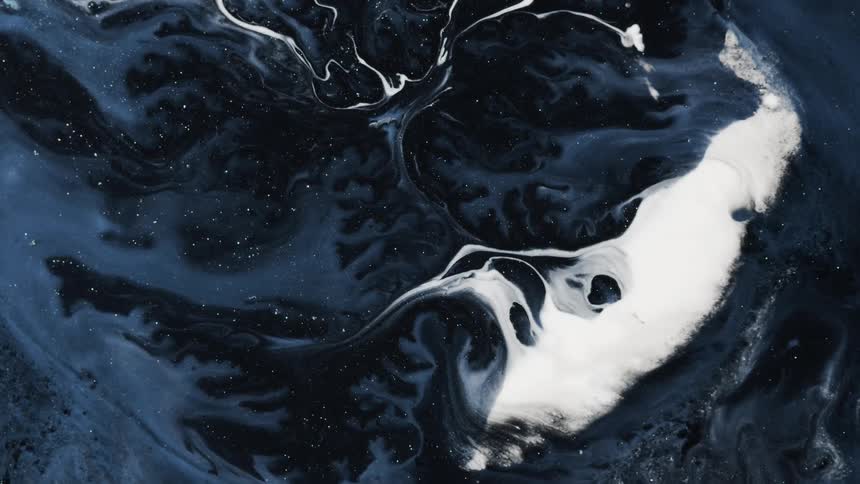 The night sky with stars seen beyond the white clouds