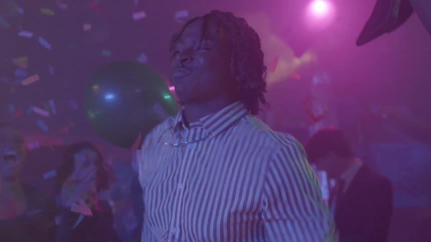 A black teenager moving to the center of a room to dance