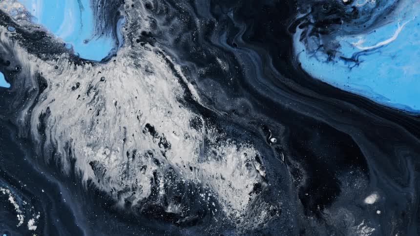 Black white and blue liquid dye swirling together