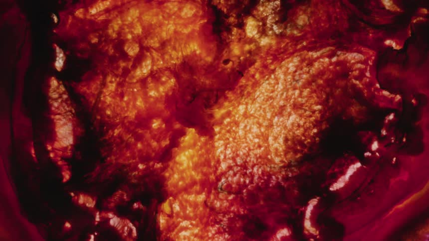 A red and orange colored painting slowly moving inward
