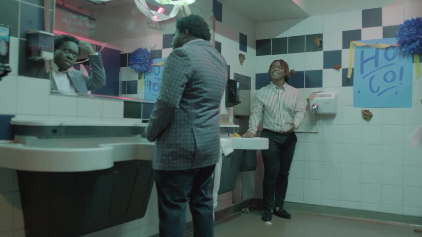 Two men walking into a bathroom at a party