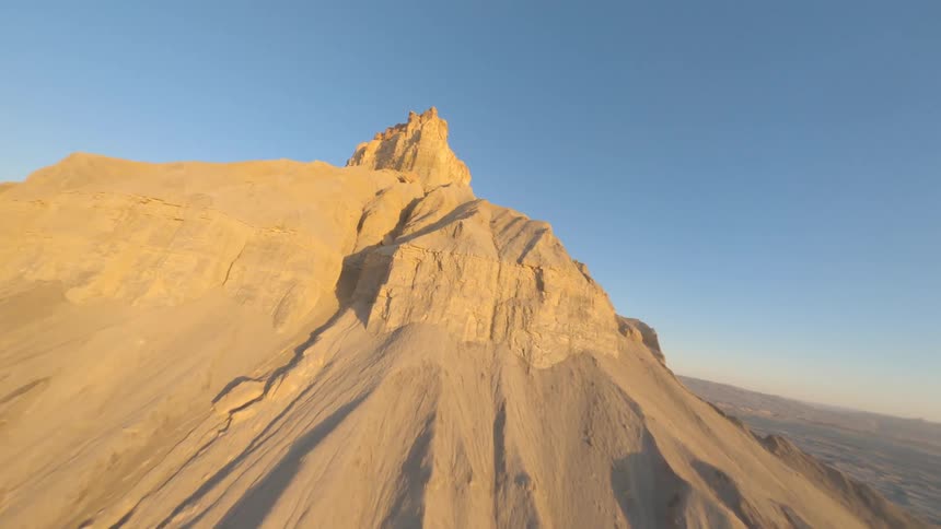 A tall mountain is in the desert