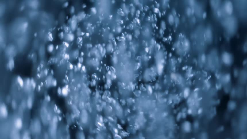 A flurry of rain, ice, and snow is swirling toward the camera