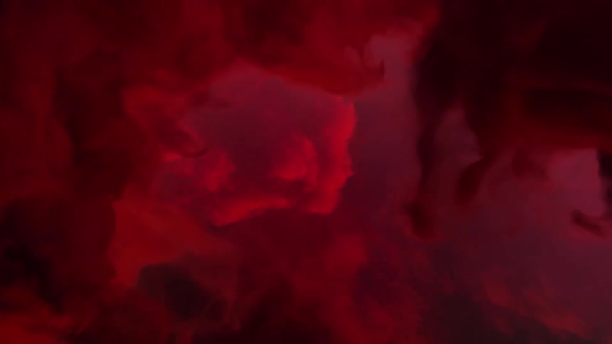 Deep red clouds glow and move in the sky