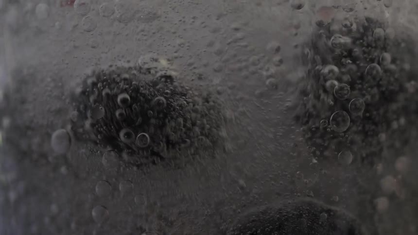Berries dance around in fizzy liquid