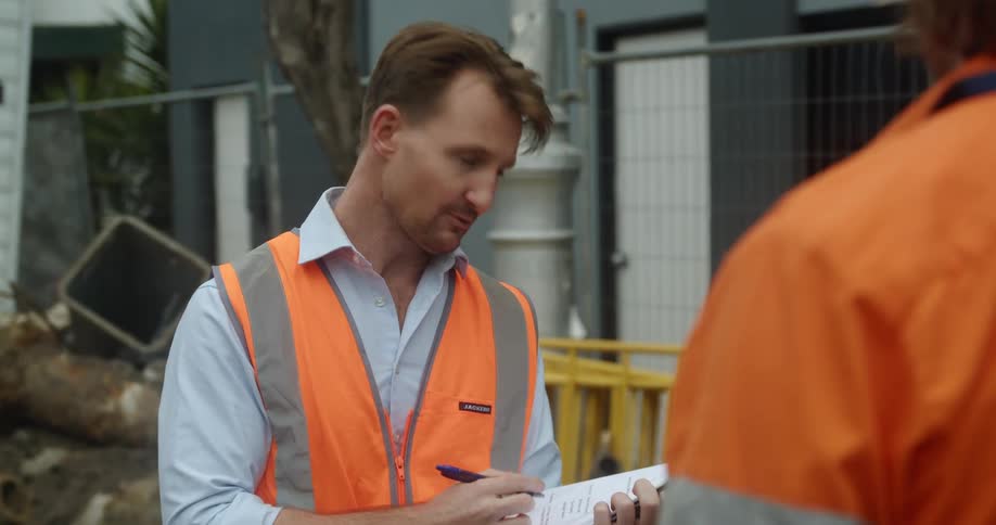 A man talking with a clipboard