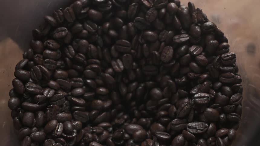 Pile of coffee beans falling inward from the center