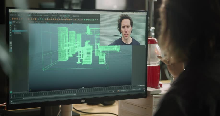 A person sitting at a computer having a video chat with a man