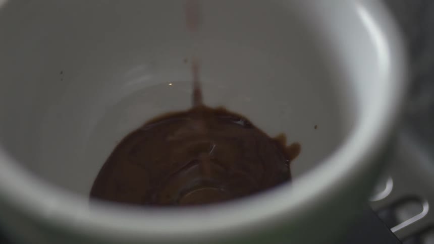 Syrup dripping into a cup