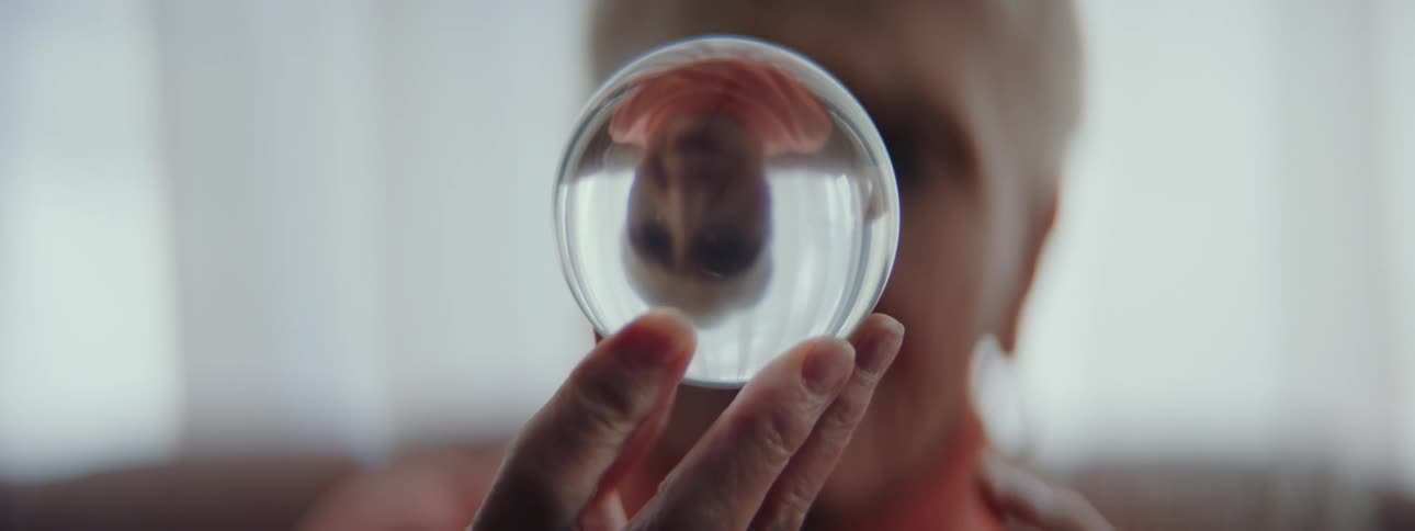 A woman holding a glass sphere