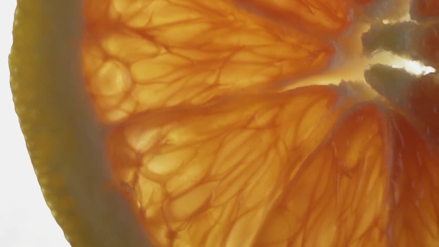 Orange is cut and on a white surface