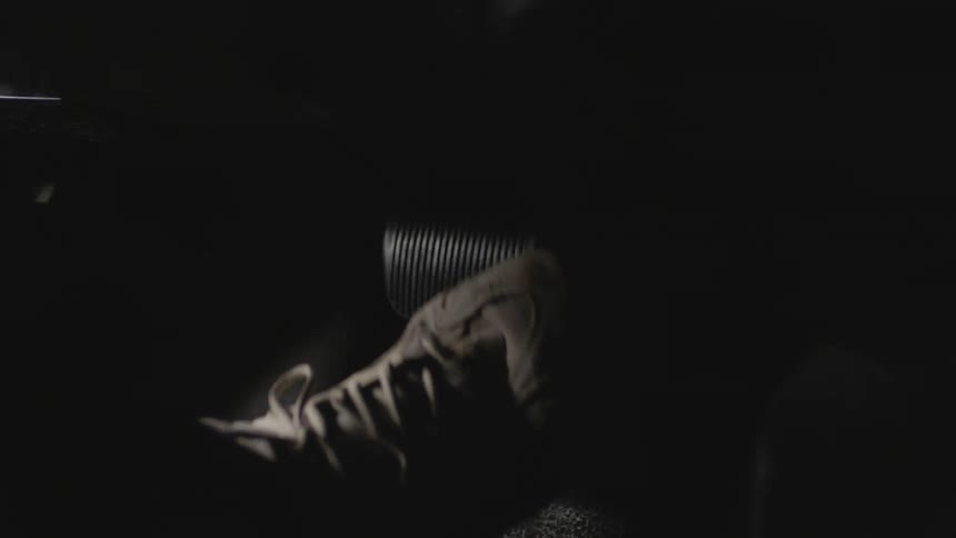 The foot of a person as they quickly move from the gas pedal to a brake in a vehicle