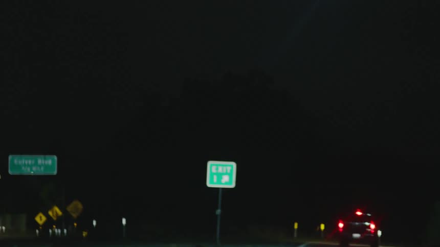 A car traveling down a highway getting off on an exit