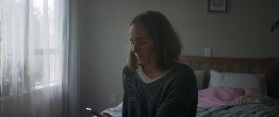 A woman in a wheelchair uses her phone