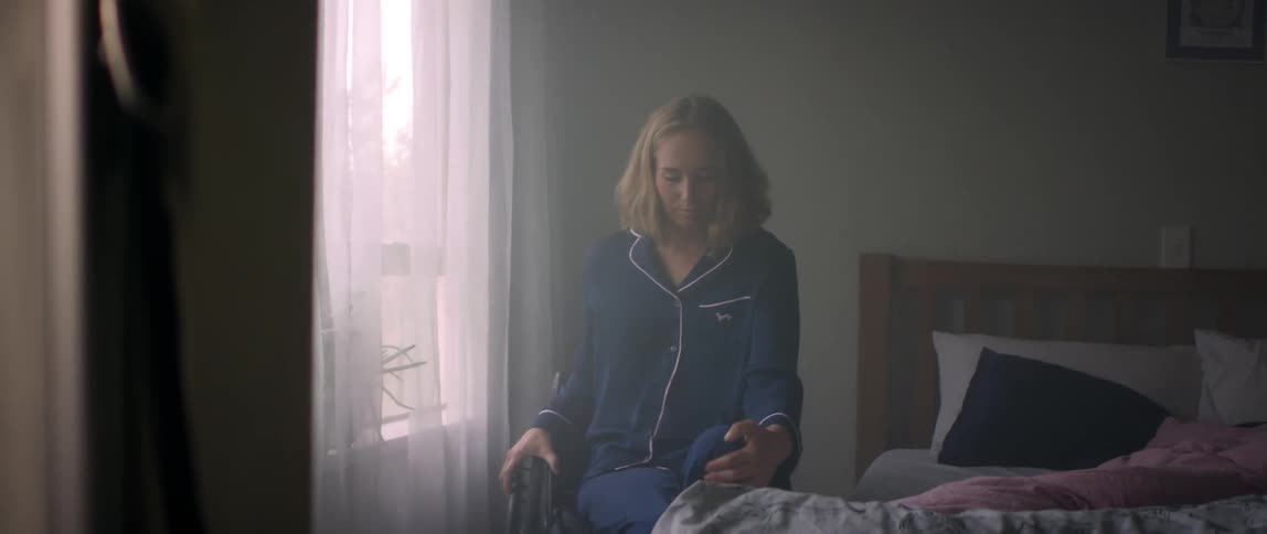 A woman getting out of bed in the morning