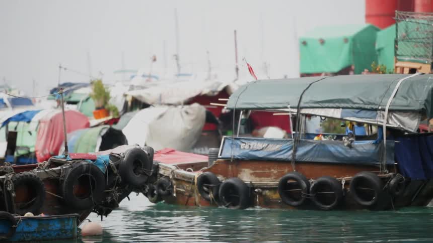 A fishing boat navigates Hong Kong Harbor