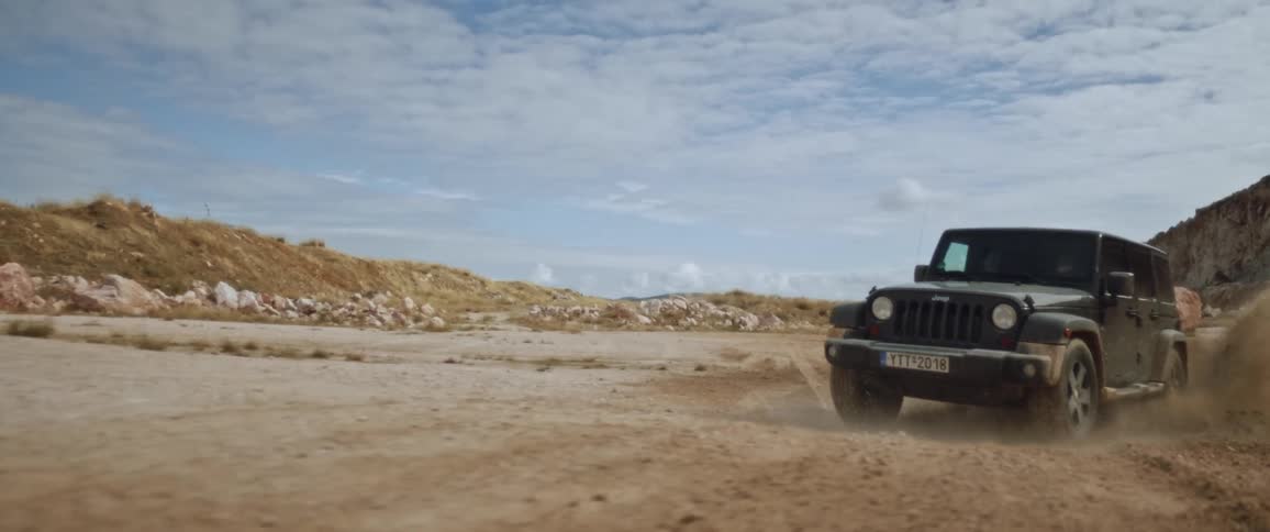 The jeep splashes through a puddle