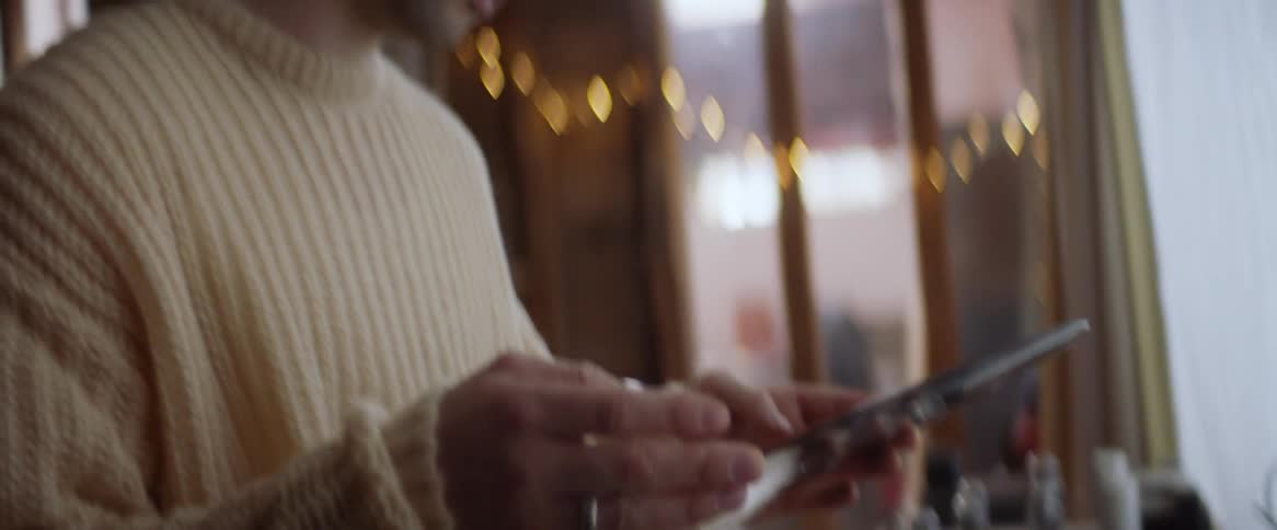 A man takes a record out of a record player and reads it