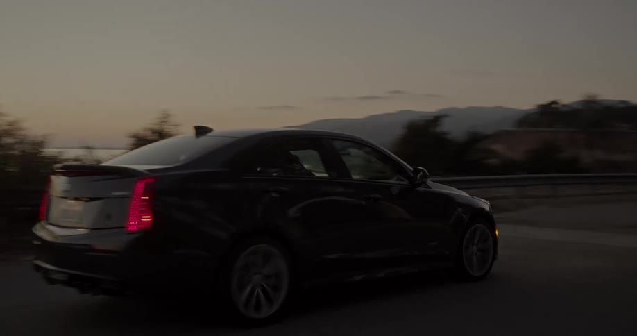 A person drives a car along the coast