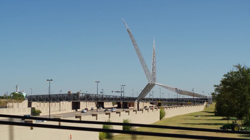 The sun shines brightly upon traffic as it moves under skydance bridge in oklahoma city