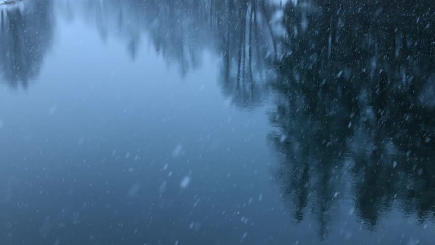 Focus on water snowing reflection on the water
