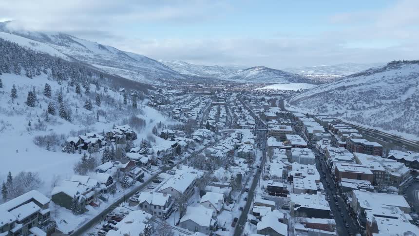 An aerial view of a mountain city in winter among mountains