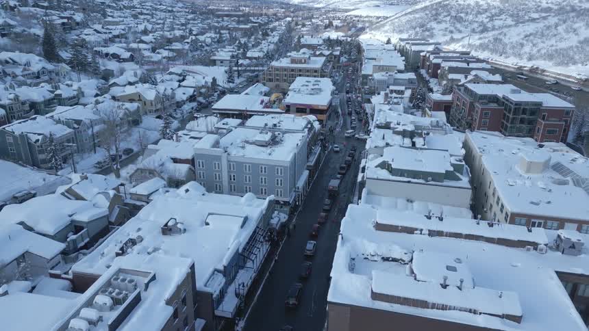 Heavy traffic passes through a snow covered town