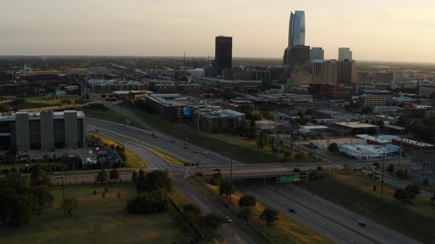 Traffic travels along a freeway through a metropolis in the evening