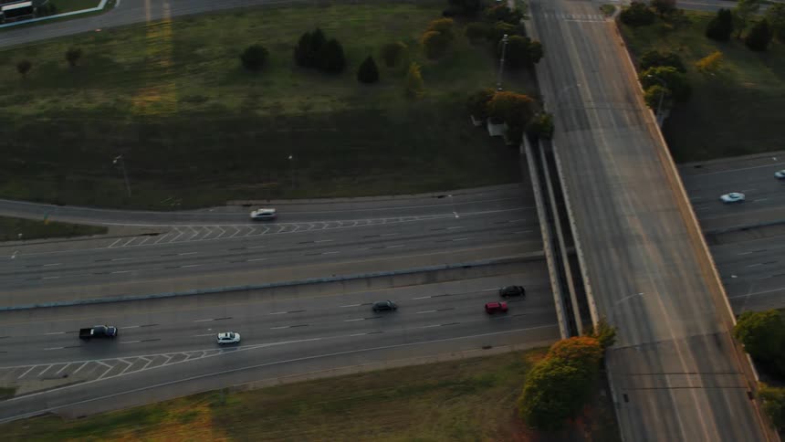 Cars driving on a freeway past businesses